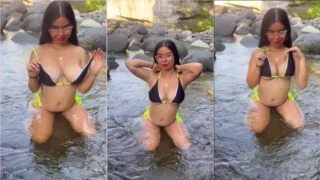 Paola Suarez in the river taking off his bikini